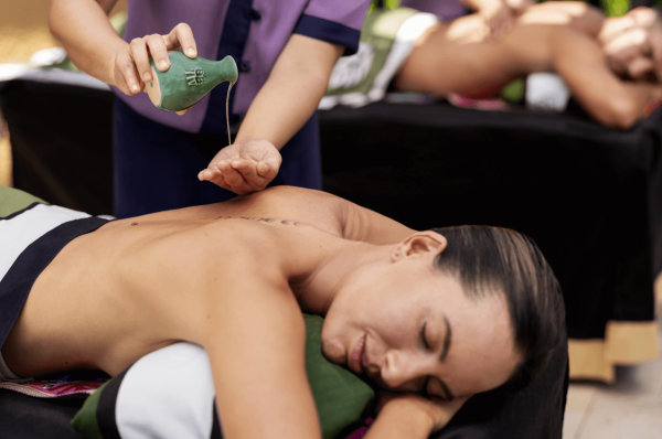 woman enjoys massage in open air mayakoba spa